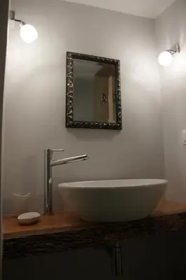 a bathroom with a sink and a mirror at Superior Apartment Near Beach in Chania Town