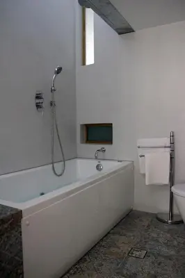 a white bathroom with a tub and a toilet at Superior Apartment Near Beach in Chania Town