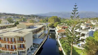 arial view of a canal in a town with houses at Irini Apartment I in Kalyves