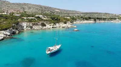 a boat floating in a large body of water at Perseus Sailing Cruises in Souda