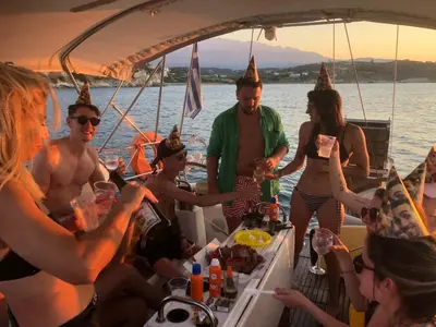 a group of people in party hats on a boat at Perseus Sailing Cruises in Souda
