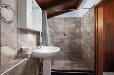 a bathroom with a sink and a shower at Seaside House in Chania Town