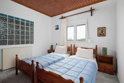a bedroom with two beds and a window at Seaside House in Chania Town