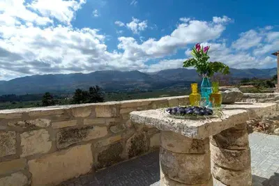 a stone table with a vase of flowers on it at Villa Iro - Private Pool & Tranquility in Káïna