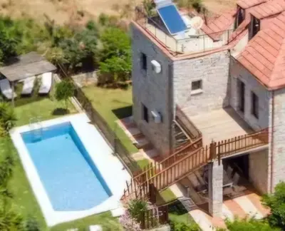 an aerial view of a house with a swimming pool at Villa Kamaraki in Patellárion