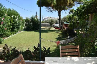 a hammock is tied to a pole in a yard at Villa Gerani in Gerani Chanion