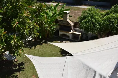 a white umbrella on the grass in a yard at Villa Gerani in Gerani Chanion