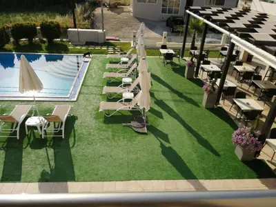an overhead view of a pool with chairs and umbrellas at Carisa Suites and Apartments in Maleme