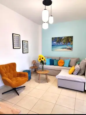 a living room with a couch and a chair at GreenView Chania Center Luxury Suite in Chania Town
