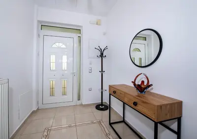 a room with a mirror and a dresser and a door at GreenView Chania Center Luxury Suite in Chania Town