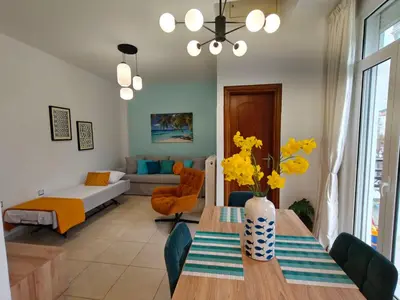 a living room with a table and a couch at GreenView Chania Center Luxury Suite in Chania Town