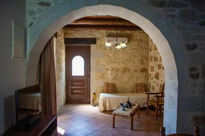 a bedroom with a bed in a stone wall at Villa Antonia in Gramvousá