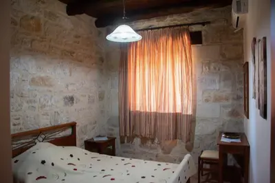 a bedroom with a bed and a window at Villa Antonia in Gramvousá