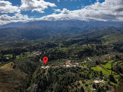 an aerial view of a town in a valley with a red marker at Achlades The Mountain Paradise Villas - Studio with pool! in Aletrouvárion