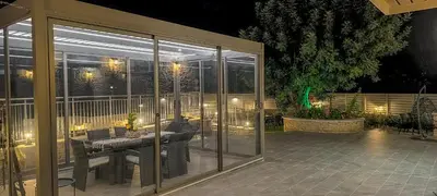 a screened in patio with a table on a patio at Achlades The Mountain Paradise Villas - Studio with pool! in Aletrouvárion