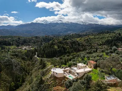 an aerial view of a house in the mountains at Achlades The Mountain Paradise Villas - Suite with pool and balcony with amazing view! in Aletrouvárion