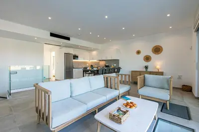 a living room with a couch and a table at Diktamos Villa by Vintage Travel in Tavronitis