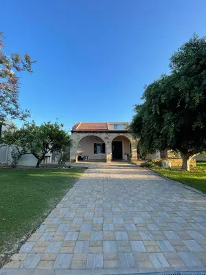 a house with a brick driveway in front of it at Maleme Maisonette in Maleme