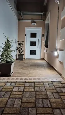 a hallway with a white door and potted plants at Maleme Maisonette in Maleme