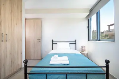 a bedroom with a bed with a towel on it at Didas Serenity Breeze in Kounoupidhianá