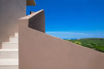 a concrete wall with a view of a mountain at Didas Serenity Breeze in Kounoupidhianá