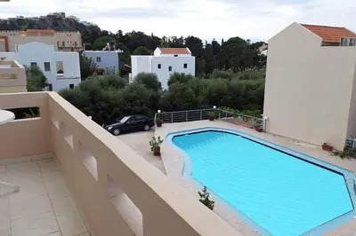 a swimming pool on the side of a building at Nik Litinas Apartments with pool in Plataniás