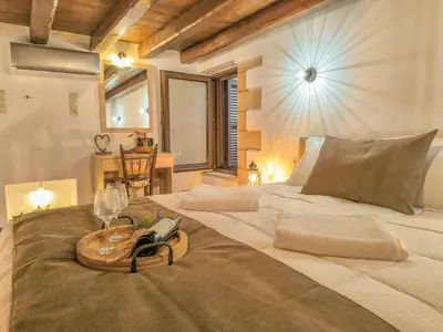 a large bed with a tray on top of it at Achlades The Mountain Paradise Villas - Maisonette with pool and amazing view! in Aletrouvárion