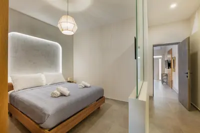 a bedroom with a bed with two towels on it at Callista City Living III in Chania Town