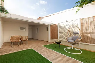 an outdoor patio with a wicker chair and a swing at Callista City Living III in Chania Town