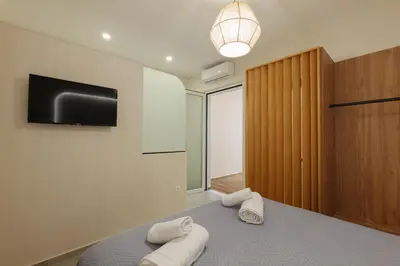 a bedroom with a bed with two towels on it at Callista City Living III in Chania Town