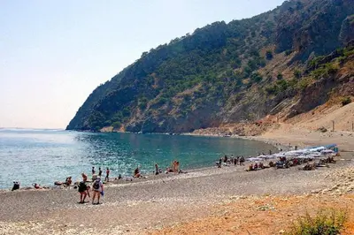 a group of people on a beach near the water at Sweet Corner Masxali in Agia Roumeli