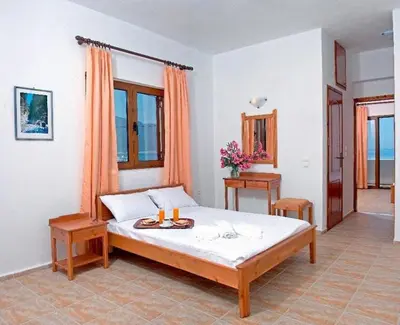 a bedroom with a bed with two candles on it at Sweet Corner Masxali in Agia Roumeli
