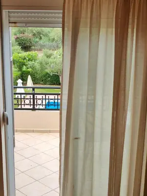 a sliding glass door with a view of a balcony at Bellavista Gardens Skoutelonas in Skoutelónas