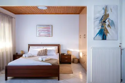 a bedroom with a bed with a wooden ceiling at Haris home in Daratso