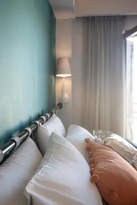 a row of pillows on a bed in a room at Elia Bettolo Hotel in Chania Town
