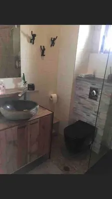 a bathroom with a sink and a toilet and a mirror at Villa Aris in Crete with private pool en private parking! in Neo Chorio