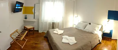 a bedroom with a bed with towels on it at Color Living in Chania Town