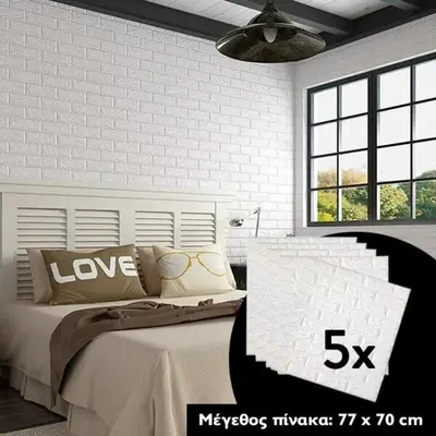 a bedroom with a large white bed with pillows at Studios Stylianos in Kounoupítsa