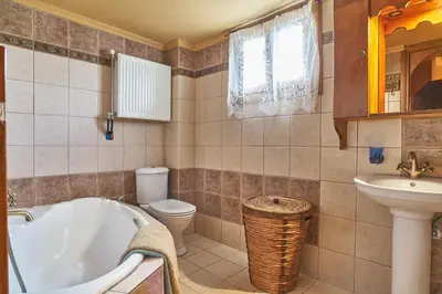 a bathroom with a tub and a toilet and a sink at Villa Evenos with private pool in Elafonisi