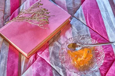 a book and a bowl of food and a spoon at Villa Evenos with private pool in Elafonisi
