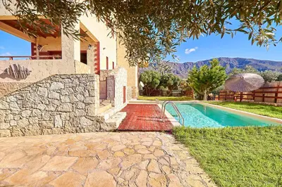 a house with a swimming pool next to a house at Villa Evenos with private pool in Elafonisi