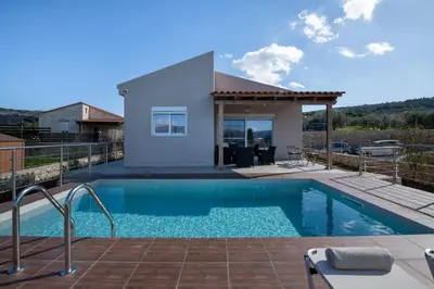 a villa with a swimming pool and a house at Villa Pervana- Private pool - Close to the Beach in Arménoi