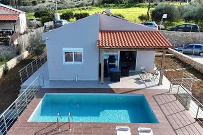 a villa with a swimming pool and a house at Villa Pervana- Private pool - Close to the Beach in Arménoi