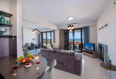 a living room with a couch and a table at Marilia by Vintage Travel in Maleme