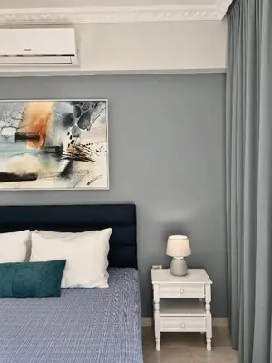 a bedroom with a bed and a painting on the wall at Nerina Home Chania in Chania Town