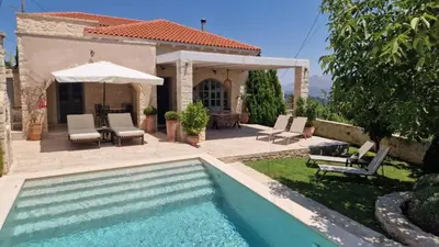 a backyard with a swimming pool and a house at Artemis Apollonas Villa I Luxury Escape with Pool in Káïna