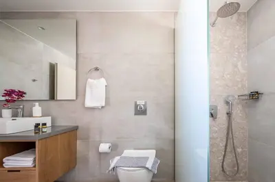 a bathroom with a shower and a toilet and a sink at Villa Eva Chania in Neo Chorio
