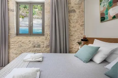 a bedroom with a bed with two towels on it at Villa Eva Chania in Neo Chorio