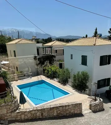 a swimming pool in front of a house at Villa Elpida Aspro in Koprána