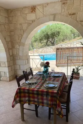 a table with chairs and a tablecloth on a table with a view at Villa Elpida Aspro in Koprána